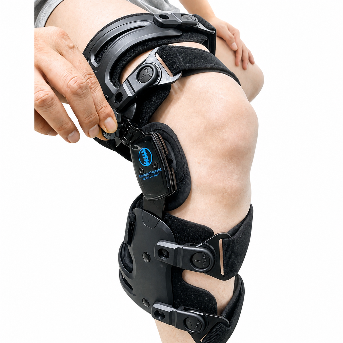 Comfyorthopedic Buckle&Tune OA knee brace worn on a leg while the built-in adjustment tool is used.